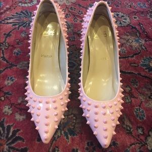 Pink spike women’s pump with red sole